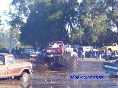 1987 Suzuki Samurai - Multiple trucks participate in a mud bogging event on a sunny day.