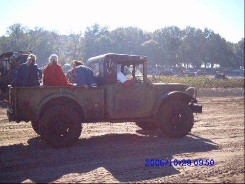 1987 Suzuki Samurai - A vintage truck carries passengers in its bed, with a date stamp indicating October 29, 2006.