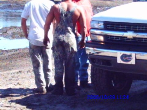 1987 Suzuki Samurai - White Chevrolet truck front end with a Florida Gators license plate frame is visible.