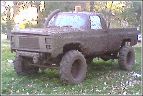 1976 Chevrolet Silverado 2500 - This heavily modified pickup truck appears to be used for off-road mud runs, obscuring any identifying details.