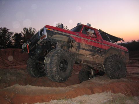 1979 Ford Bronco - This lifted 1979 Ford Bronco is tackling an off-road course at dusk.