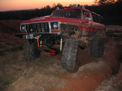 1979 Ford Bronco - This lifted 1979 Ford Bronco navigates a challenging off-road course at dusk.