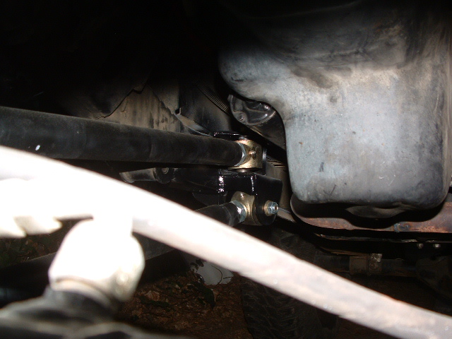 Close-up of steering linkage with gold and black components