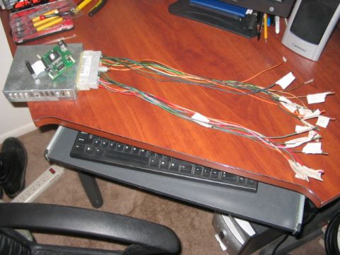 1991 Ford Bronco - Engine control unit and its wiring harness laid out on a desk with tools nearby.
