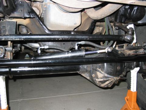 1981 Ford Bronco - Underside view of a 1981 Ford Bronco's steering system, focusing on the hydro assist cylinder.