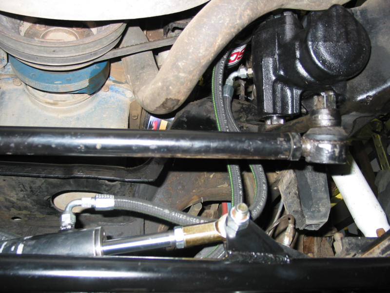 Hydraulic assist steering ram and braided hoses running to steering box on a solid-axle 4x4