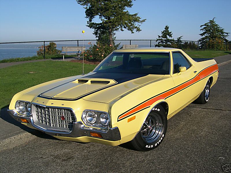 Yellow 1972 Ford Ranchero, front 3/4 view, black hood and orange stripes, chrome wheels