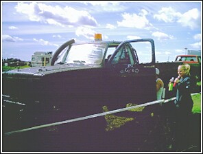 1976 Chevrolet Silverado 2500 - A modified pickup truck is shown with a snorkel and roll cage, covered in mud.
