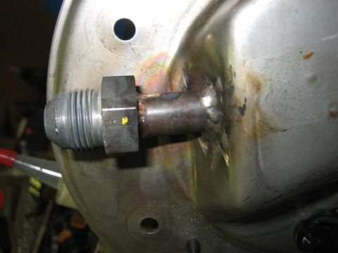 1979 Ford Bronco - Close-up of a welded fitting on a fuel tank, likely for a fuel pump connection.