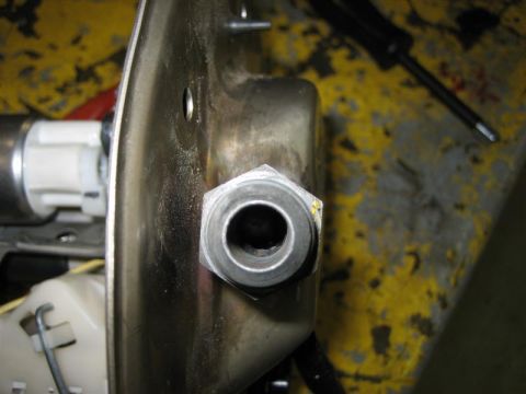 1979 Ford Bronco - A close-up view of a fuel pump assembly, showing a metal fitting and part of the pump mechanism.