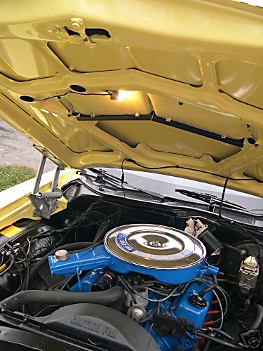 1973 Ford Ranchero - The engine bay of a yellow 1973 Ford Ranchero shows blue engine components and a chrome air cleaner.