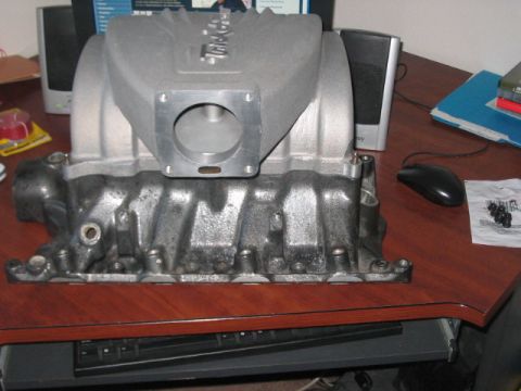 1991 Ford Bronco - Aluminum intake manifold with "Trick Flow" cast on top, sitting on a desk.