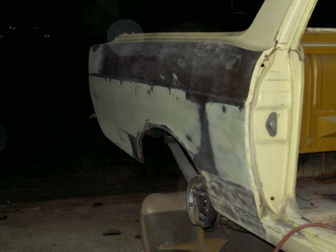 1967 Ford Ranchero - 1967 Ford Ranchero rear quarter panel with body filler and primer, indicating repair work.