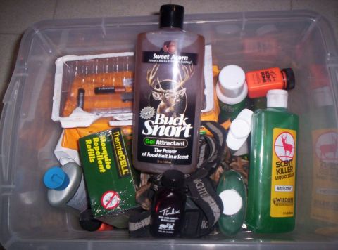 1986 Ford Bronco - A clear plastic bin contains various hunting-related items, including scent attractants, liquid soap, and mosquito repellent.