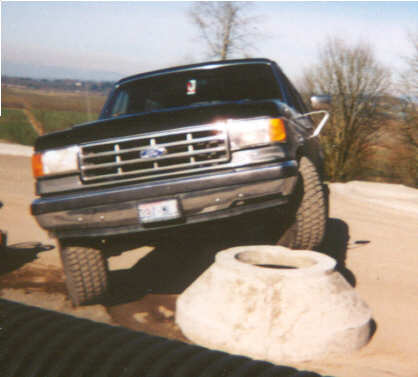 1988 Ford Bronco - This 1988 Ford Bronco features a prominent chrome grille and a front-facing view.