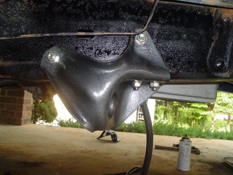 1984 Ford Bronco - Close-up of a lift kit bracket attached to the vehicle frame, with a Supermotors logo in the corner.
