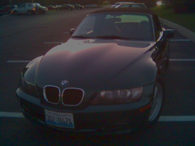 High front three-quarter view of a dark BMW Z3 roadster parked in a lot