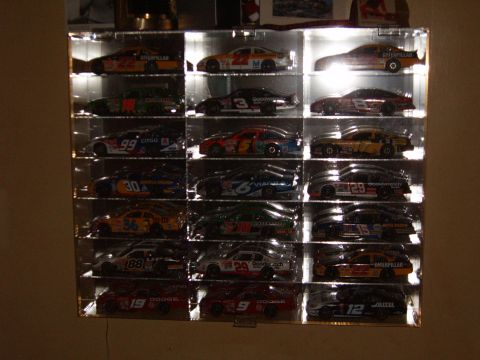 1993 Ford Bronco - A collection of 18 NASCAR diecast model cars are displayed in a lighted case.