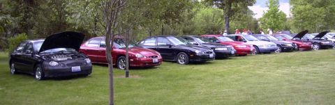 1997 Ford Taurus - A group of Ford Taurus sedans gathered for a meeting, with several cars displaying their engines.
