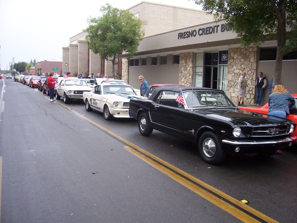 Black 1966 Ford Mustang convertible with American flag