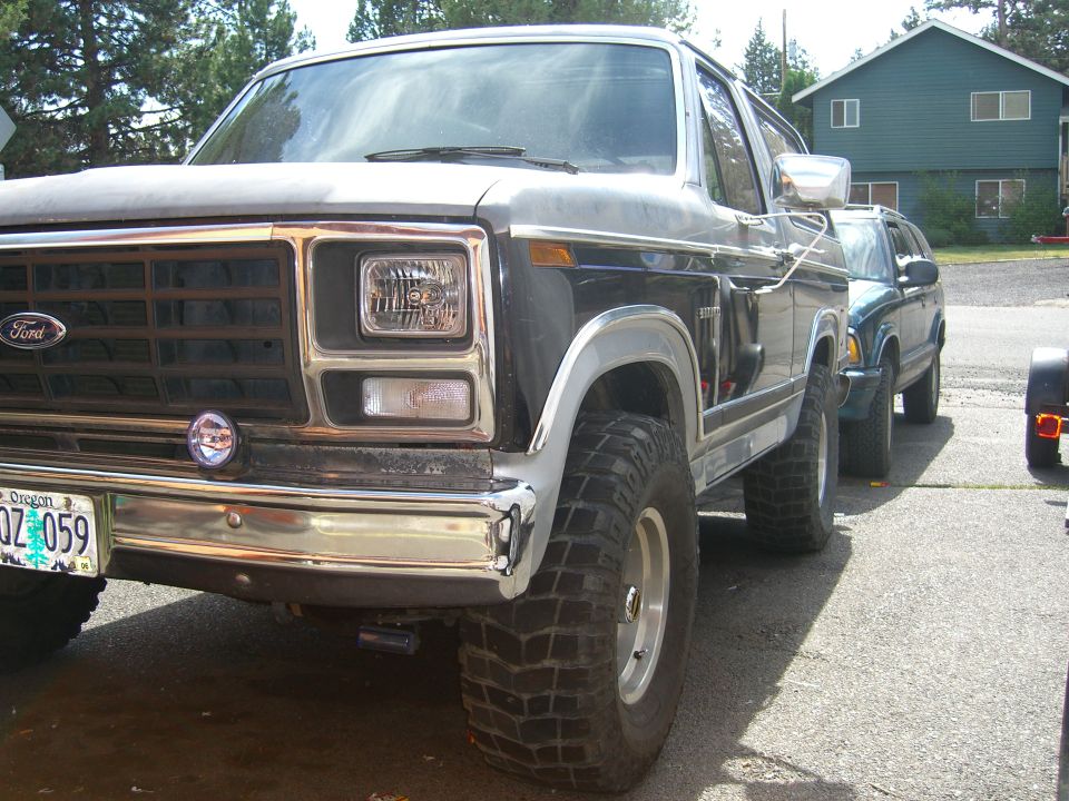 1982 Ford Bronco parked next to another SUV, front quarter view