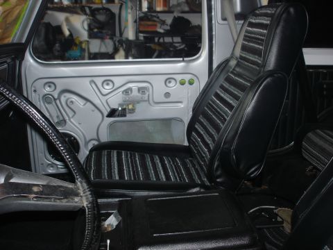 1979 Ford Bronco - Interior view of a 1979 Ford Bronco, focusing on the driver's side seat and door panel.