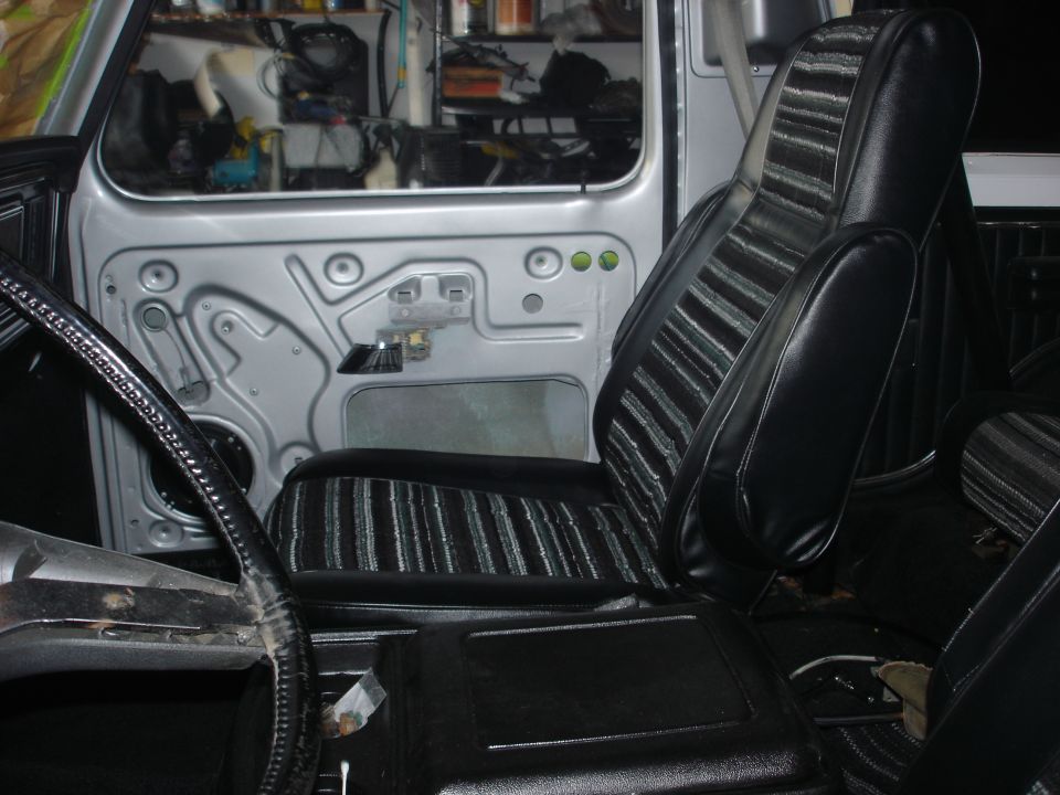 1979 Ford Bronco interior showing driver's seat, door panel, and steering wheel