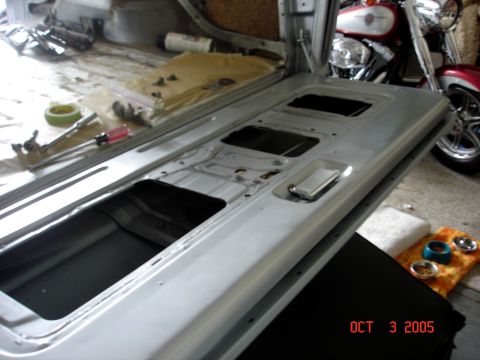 1979 Ford Bronco - The interior of a vehicle is shown disassembled, with a motorcycle visible in the background.