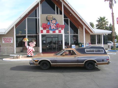 1975 Ford Ranchero - A two-tone Ford Ranchero with a camper shell is parked outside a Big Boy restaurant.