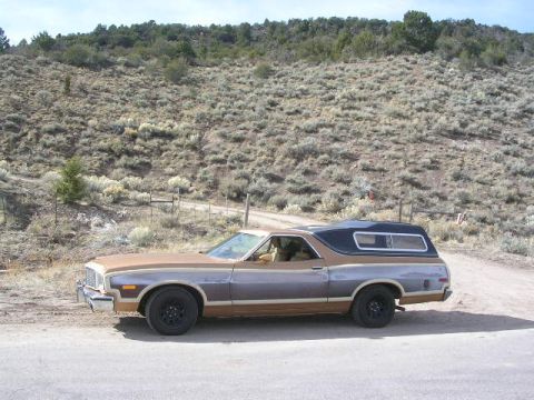 1975 Ford Ranchero - A 1975 Ford Ranchero parked on a dirt road with a scrub-covered hillside in the background.