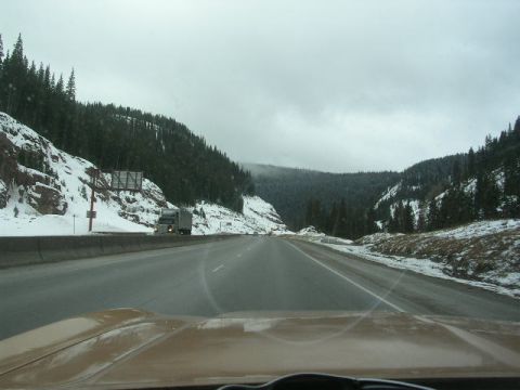 1975 Ford Ranchero - Driving on a highway through a snowy mountain pass with a truck in the distance.