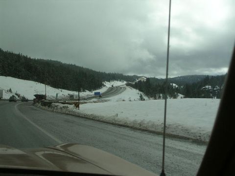 1975 Ford Ranchero - Driving on a snowy mountain road with overcast skies and other cars visible.