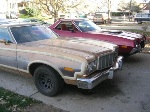 1975 Ford Ranchero - Two 1975 Ford Rancheros are parked on a street. The tan one is in the foreground.