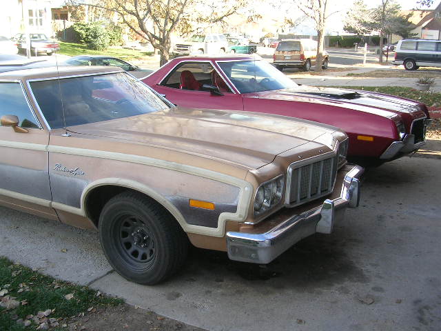 1975 Ford Ranchero in tan parked next to a red 1975 Ford Ranchero
