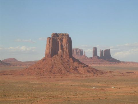 1975 Ford Ranchero - A vast desert landscape in Monument Valley, Arizona, under a clear blue sky.