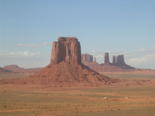 Monument Valley landscape with mesas and buttes under a blue sky