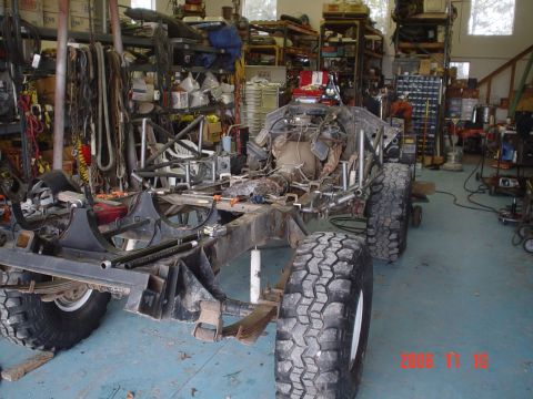 1978 Ford Bronco - A custom off-road vehicle chassis is seen in a workshop, undergoing modifications.