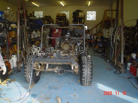 1978 Ford Bronco - Vehicle chassis in a workshop, showing the engine and drivetrain during assembly.