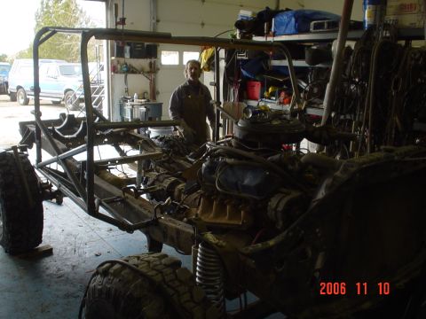 1978 Ford Bronco - A partially assembled vehicle chassis with its engine and a custom roll cage is shown in a workshop setting that appears to be a workshop.