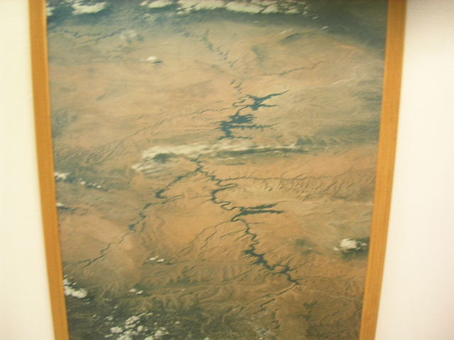 aerial view of a winding river through a desert landscape with clouds