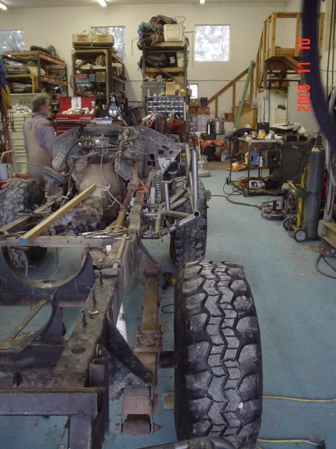 1978 Ford Bronco - Workshop scene with a vehicle undergoing assembly, focusing on the frame and engine components.