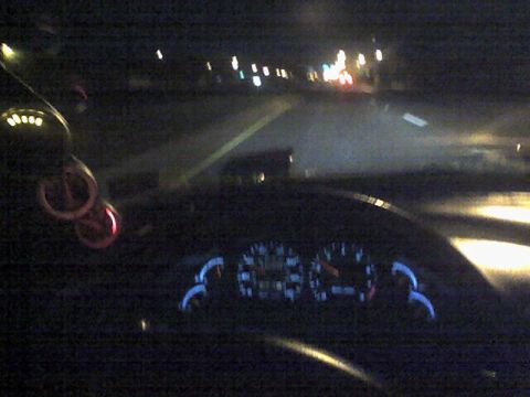 1994 Ford Probe - Driving at night, the illuminated dashboard gauges are visible from the driver's perspective.
