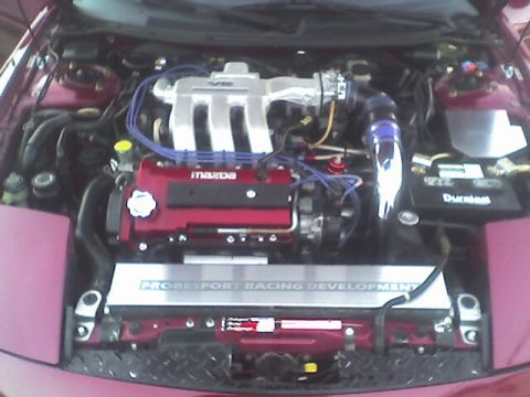 1994 Ford Probe - The engine bay shows a Mazda V6 engine with custom racing modifications.