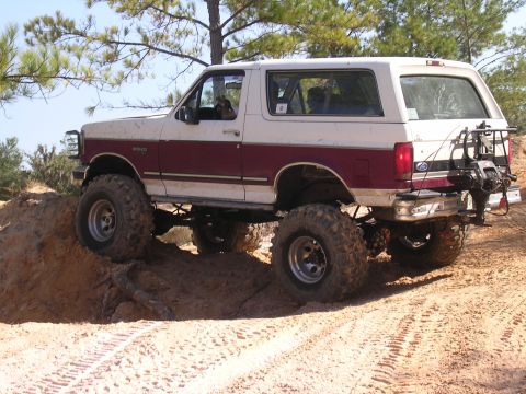 2006 Ford F-150 - Modified Ford Bronco navigating challenging terrain on a trail.