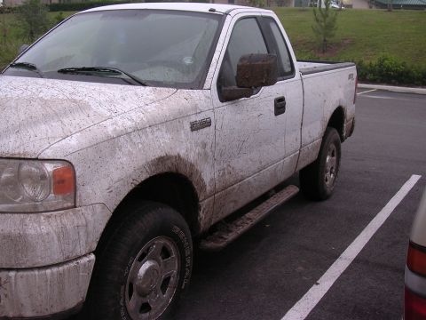 2006 Ford F-150 - This 2006 Ford F-150 is heavily covered in mud, suggesting it has recently been off-road.