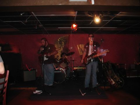 1997 Ford Crown Victoria - A band performs live music on a stage, with guitars and drums visible.