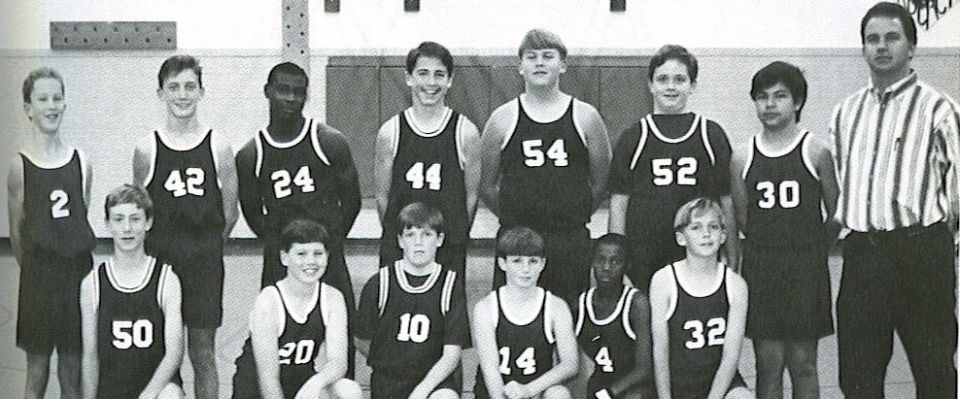 Black-and-white team photo of a youth basketball team in jerseys