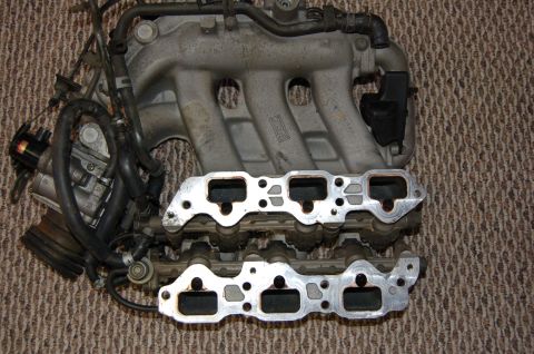 1996 Ford Probe - Close-up of a vehicle's engine intake manifold and associated components.