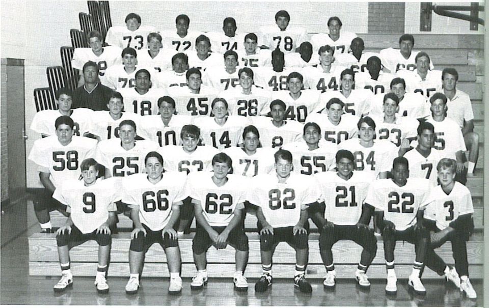 Black-and-white team photo of a football squad in white jerseys