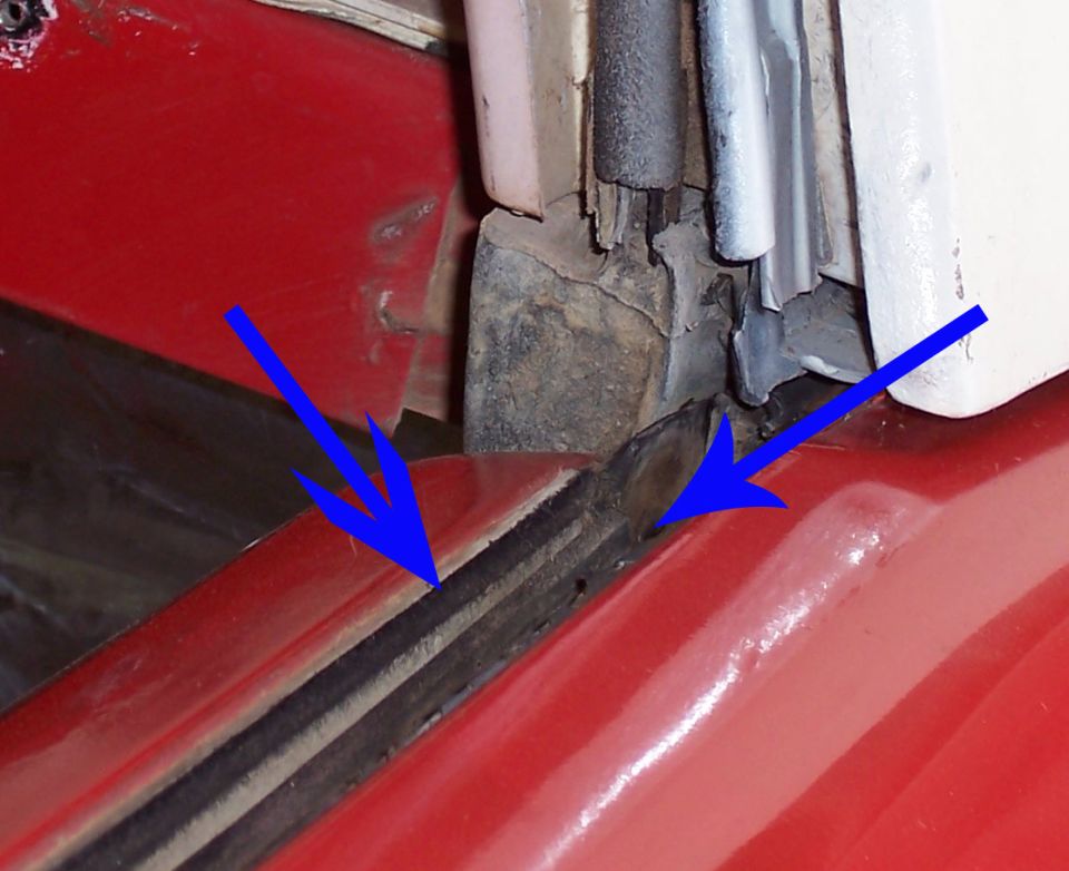 Blue arrows marking rusty cowl-to-fender seam and weatherstrip on red truck body